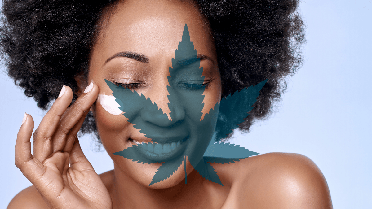 Ministry of Hemp selected the best CBD skin care and hemp beauty products out of dozens on the market. Photo: A black woman with natural hair smiles as she applies a skin care product to her cheek. A hemp leaf is superimposed on the image.