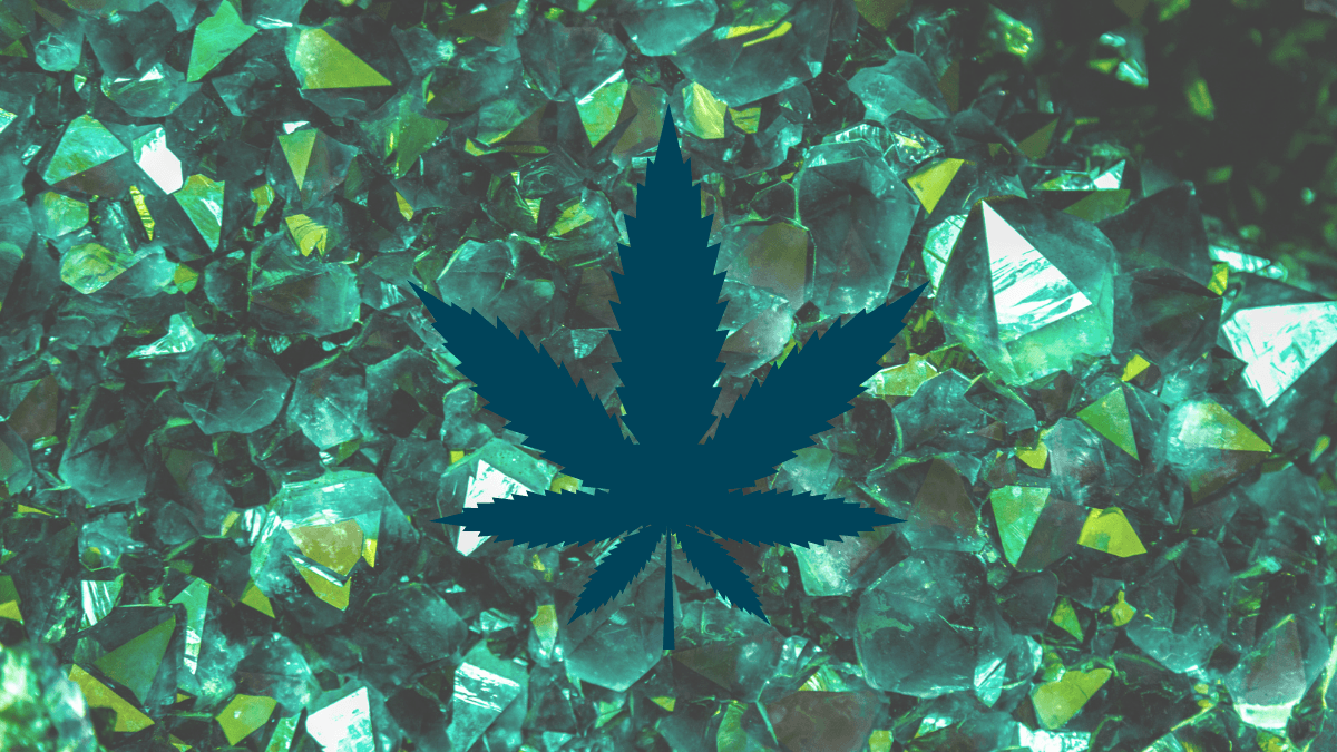 CBD cocrystals could improve bioavailability and change how we take CBD. Photo: Green crystals such as emeralds, clustered together naturally. A dark green hemp leaf is superimposed on the image.